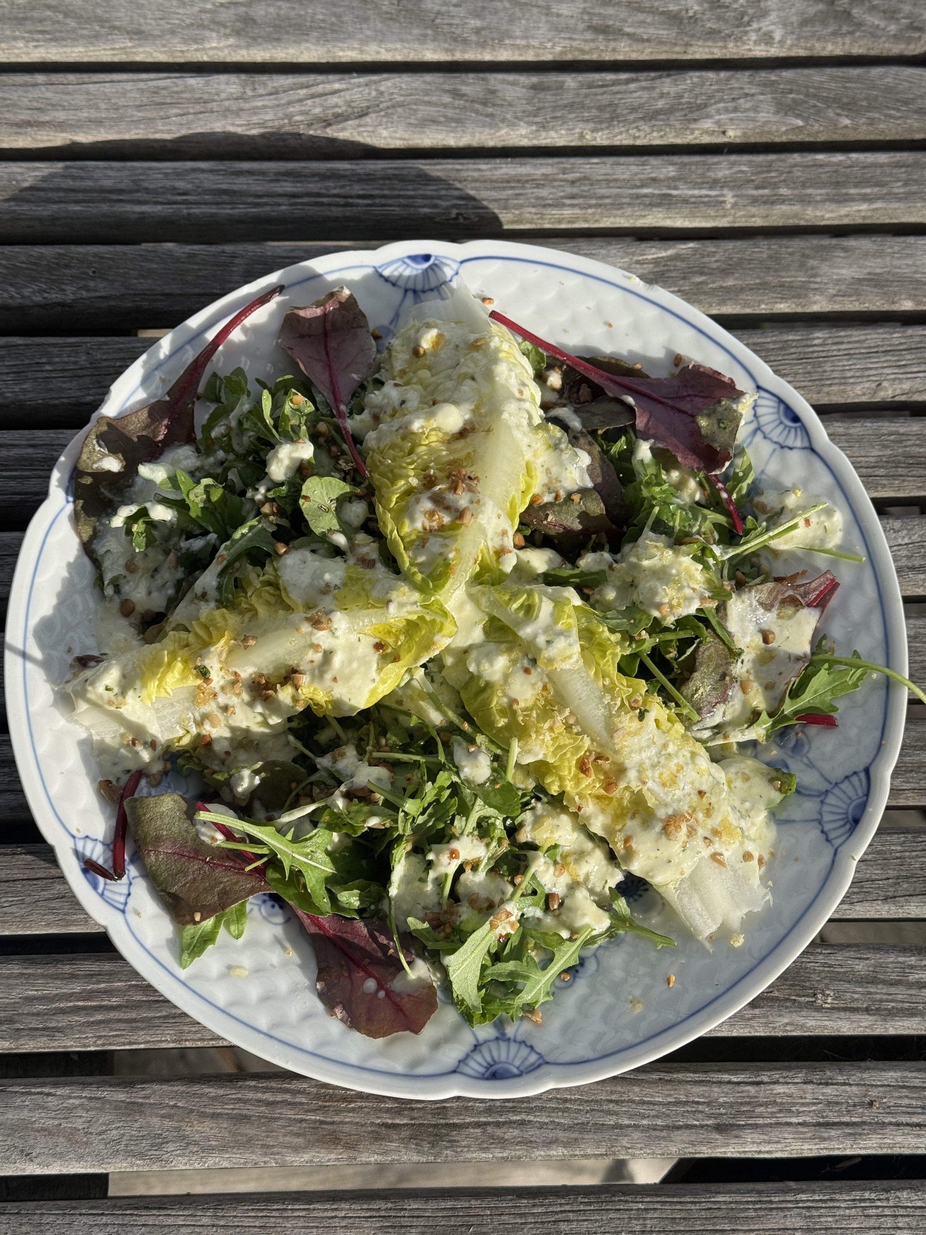 Whipped feta and mint salad dressing on an outdoor table with Honest Toil olive oil